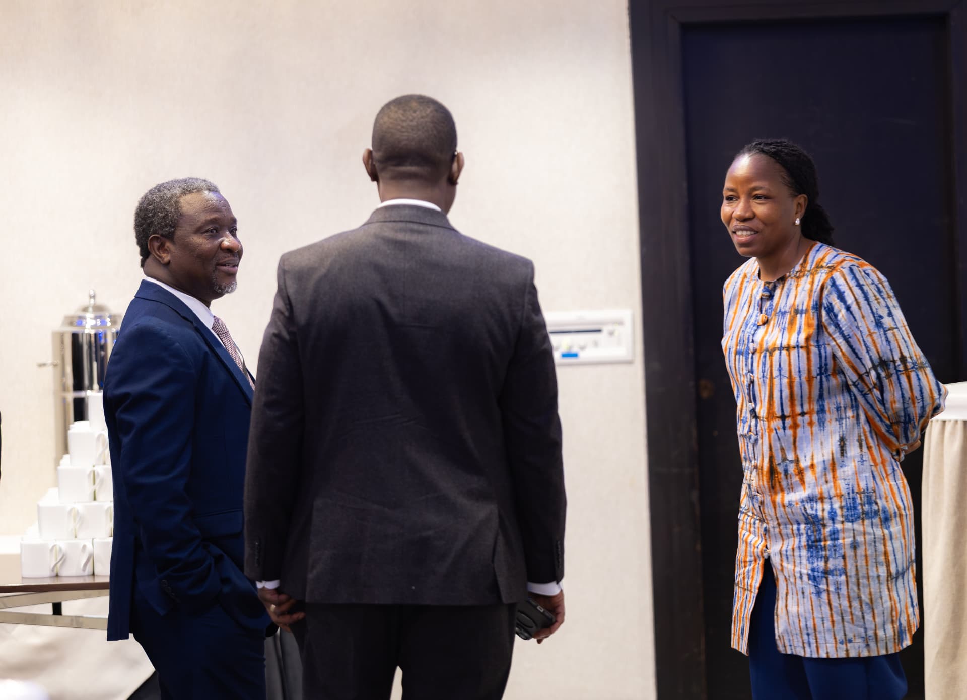 Delegates exchanging greetings in the conference hospitality area between sessions