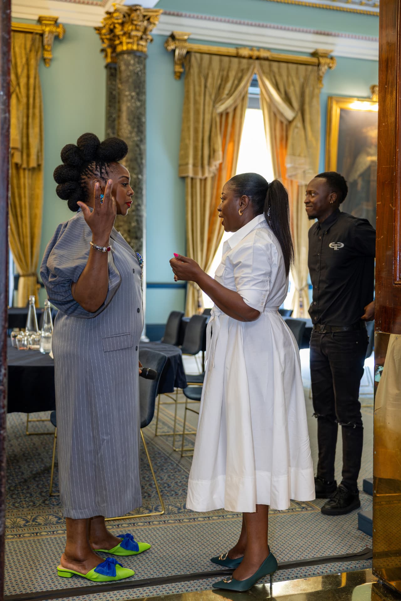 The founder in conversation with a speaker at the Institute of Directors