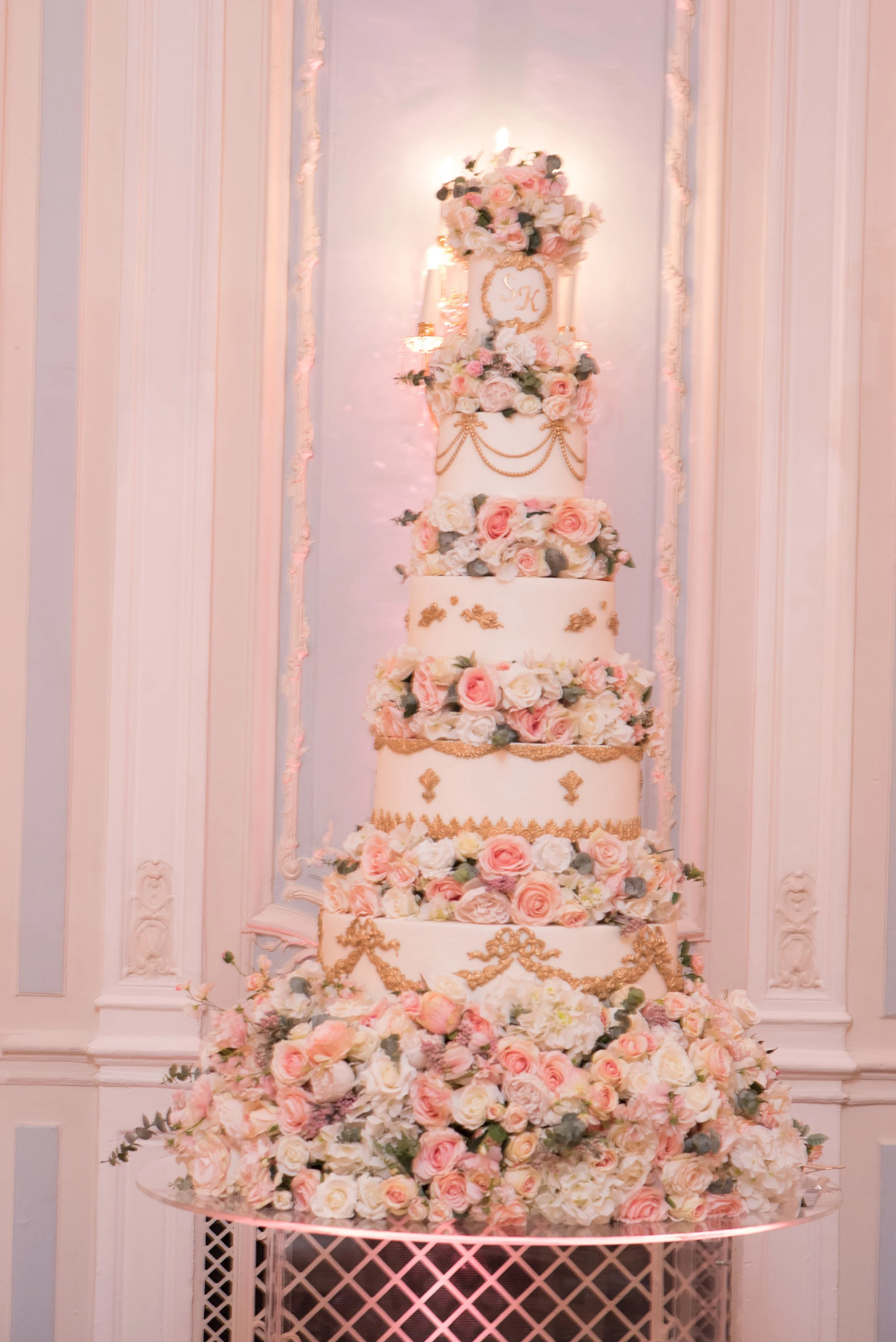 Six-tier blush and ivory wedding cake with sugar florals
