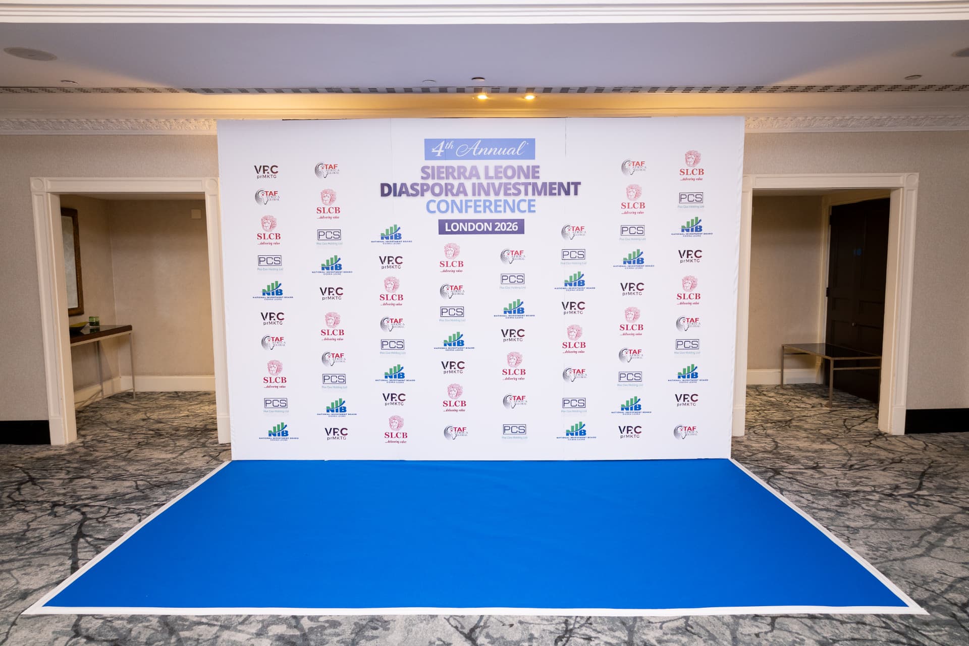 The conference step and repeat backdrop, printed with partner logos, ready for arrivals