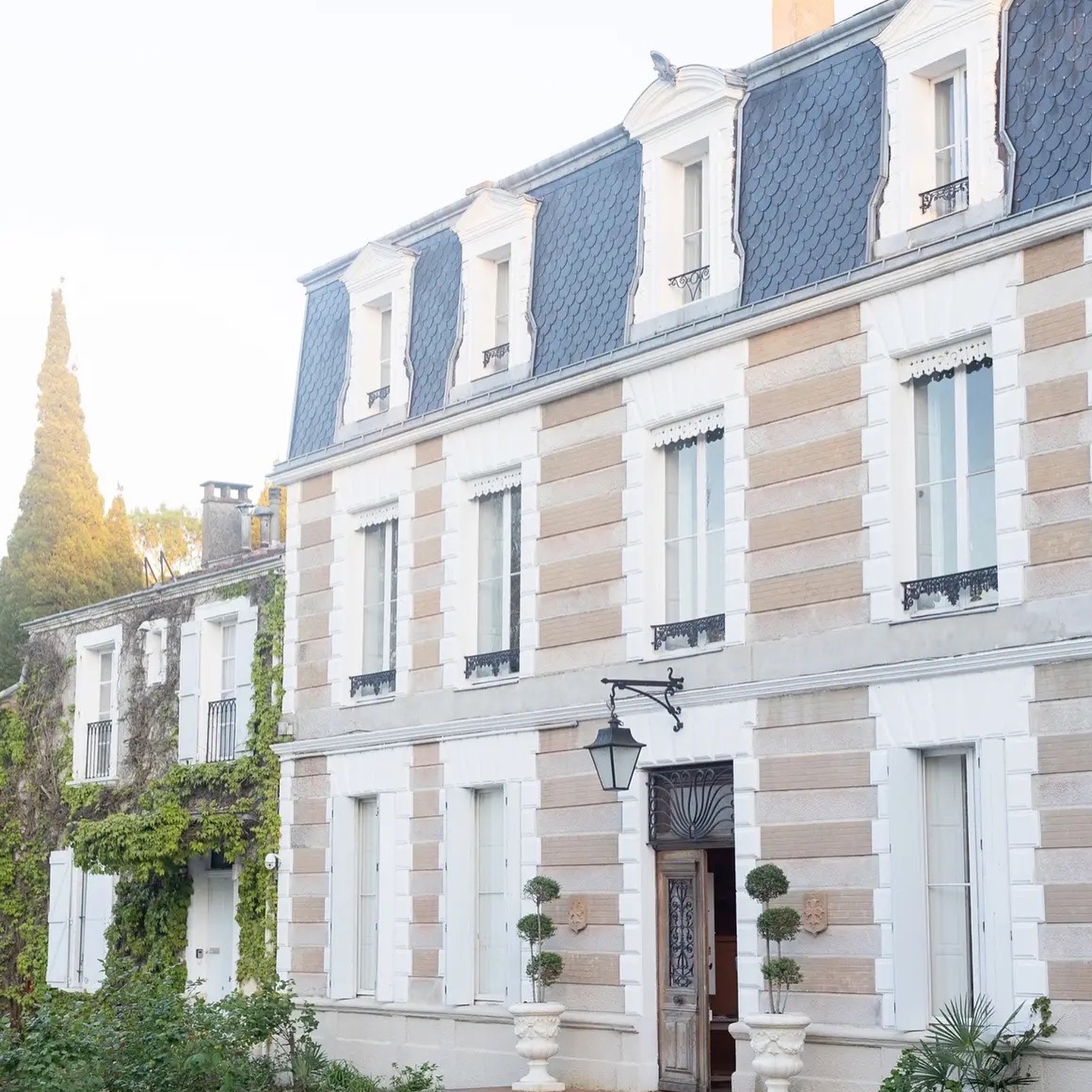 The pale stone facade and slate mansard roof of Château Saint Joseph in the south of France