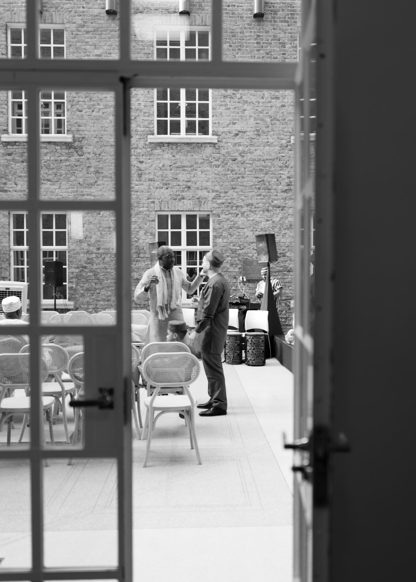 Black and white view through a doorway into the courtyard of the London wedding venue