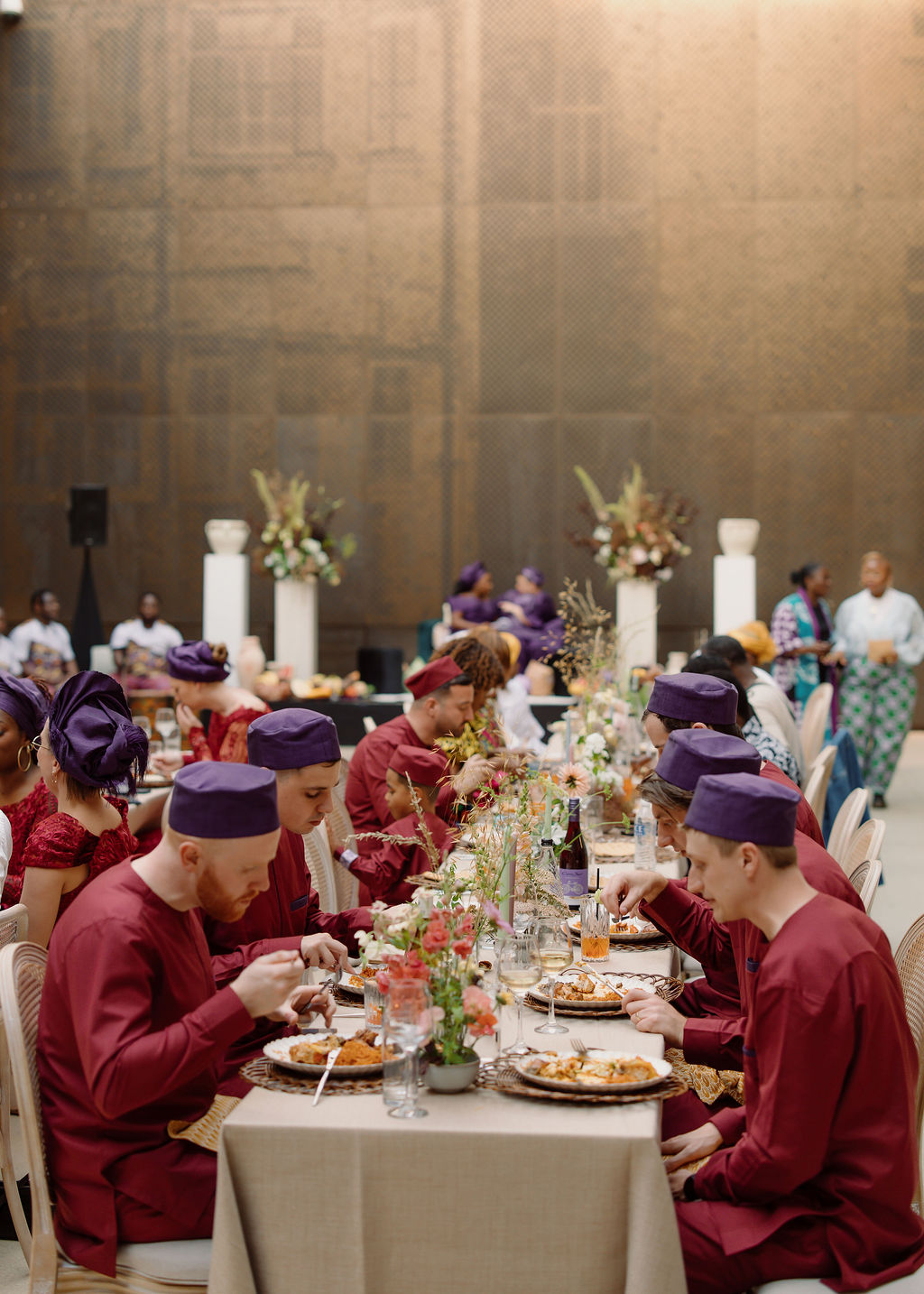 Long table dinner in a brass-clad London hall during an Anglo-African celebration