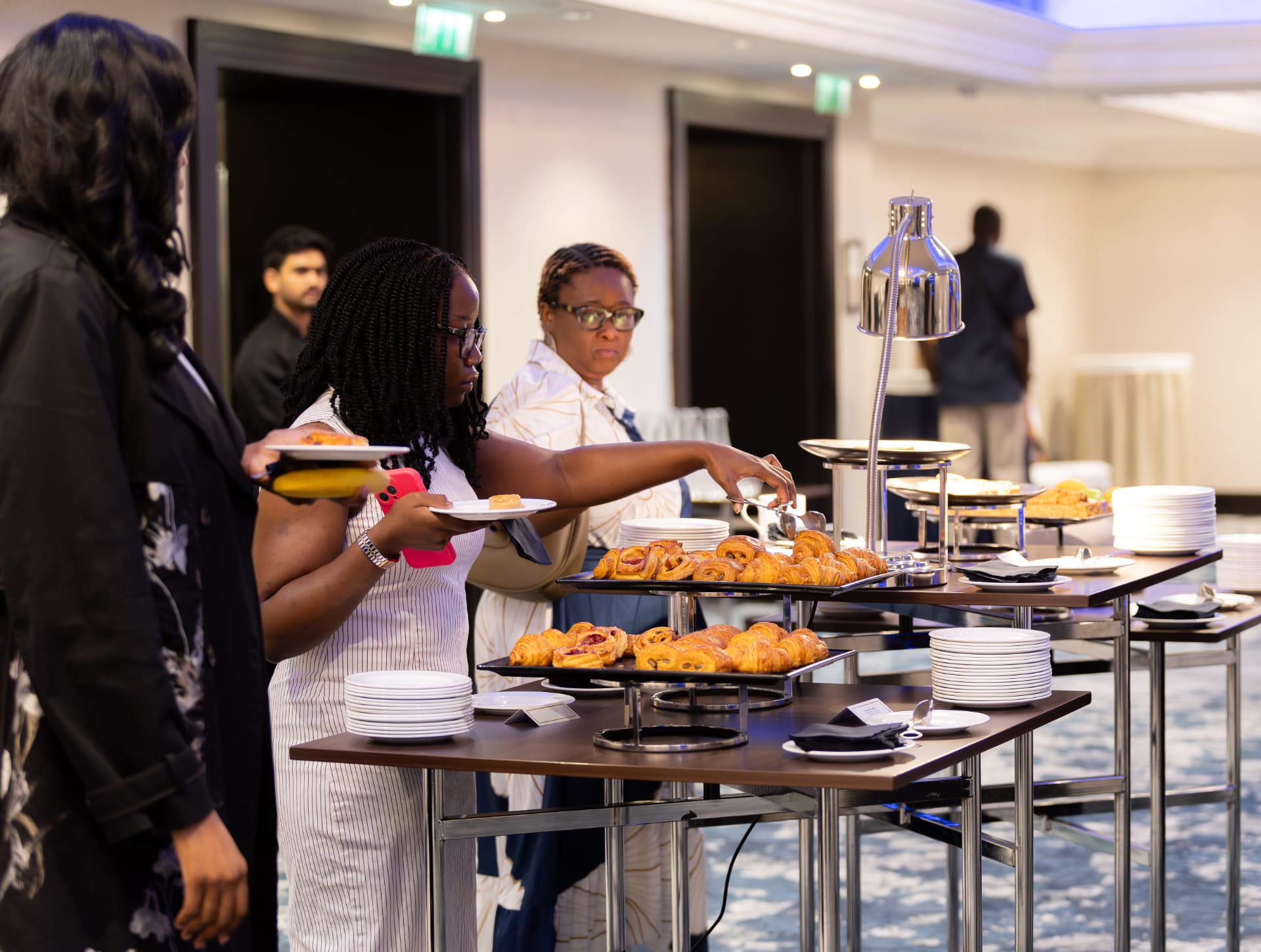 Delegates served pastries at the conference hospitality station during a break